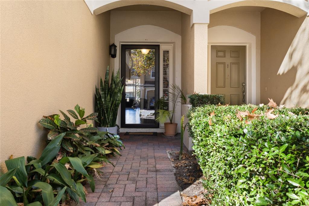 6435 Ranelagh Drive, Unit 104 Orlando, FL 32835 - Photo 3 of 36 a front view of a house with a flower garden