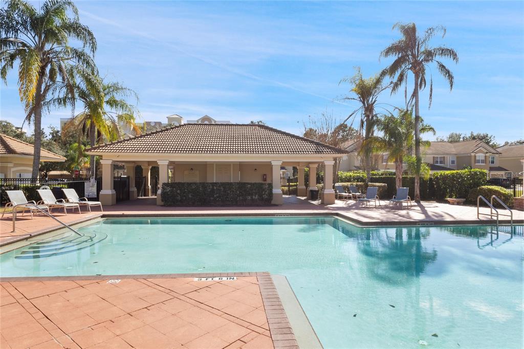 6435 Ranelagh Drive, Unit 104 Orlando, FL 32835 - Photo 33 of 36 a front view of a house with swimming pool having outdoor seating