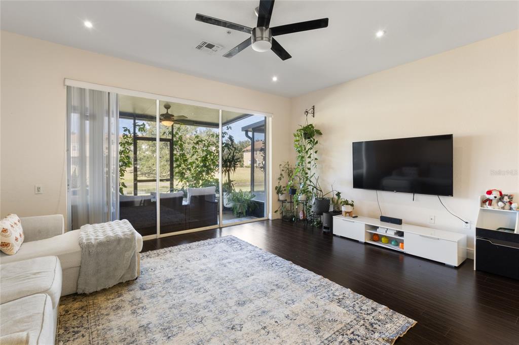6435 Ranelagh Drive, Unit 104 Orlando, FL 32835 - Photo 4 of 36 a living room with furniture and a flat screen tv