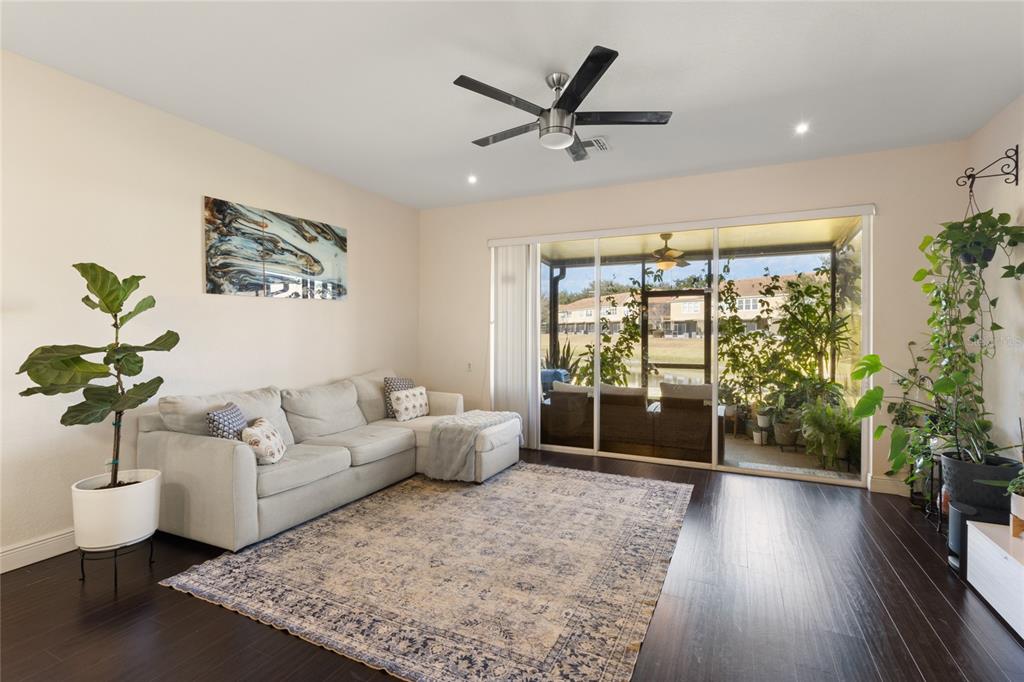 6435 Ranelagh Drive, Unit 104 Orlando, FL 32835 - Photo 5 of 36 a living room with furniture and a large window