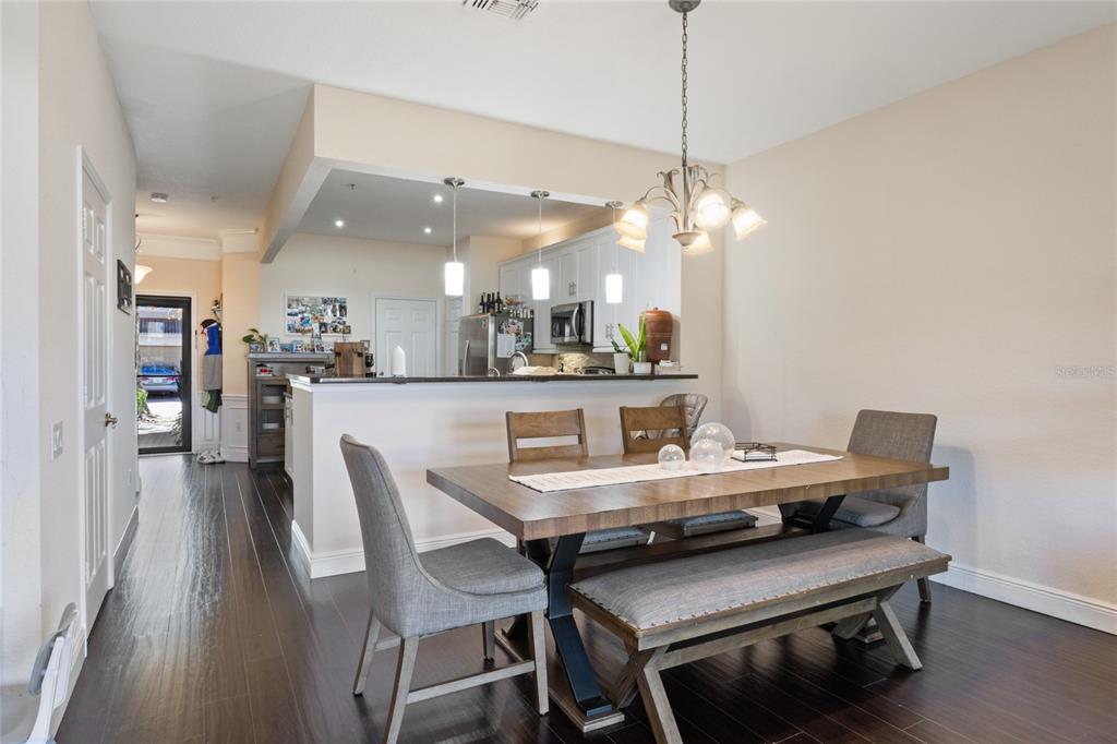 6435 Ranelagh Drive, Unit 104 Orlando, FL 32835 - Photo 10 of 36 a dining room with furniture and window