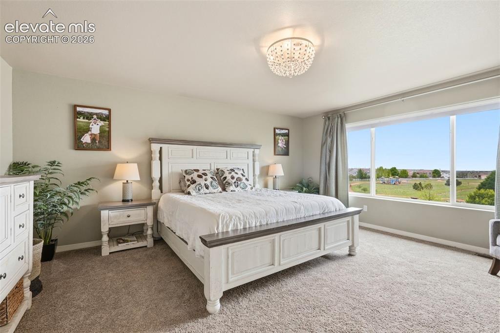 2264 Reed Grass Way Colorado Springs, CO 80915 - Photo 30 of 50 a bed room with a bed and a large window