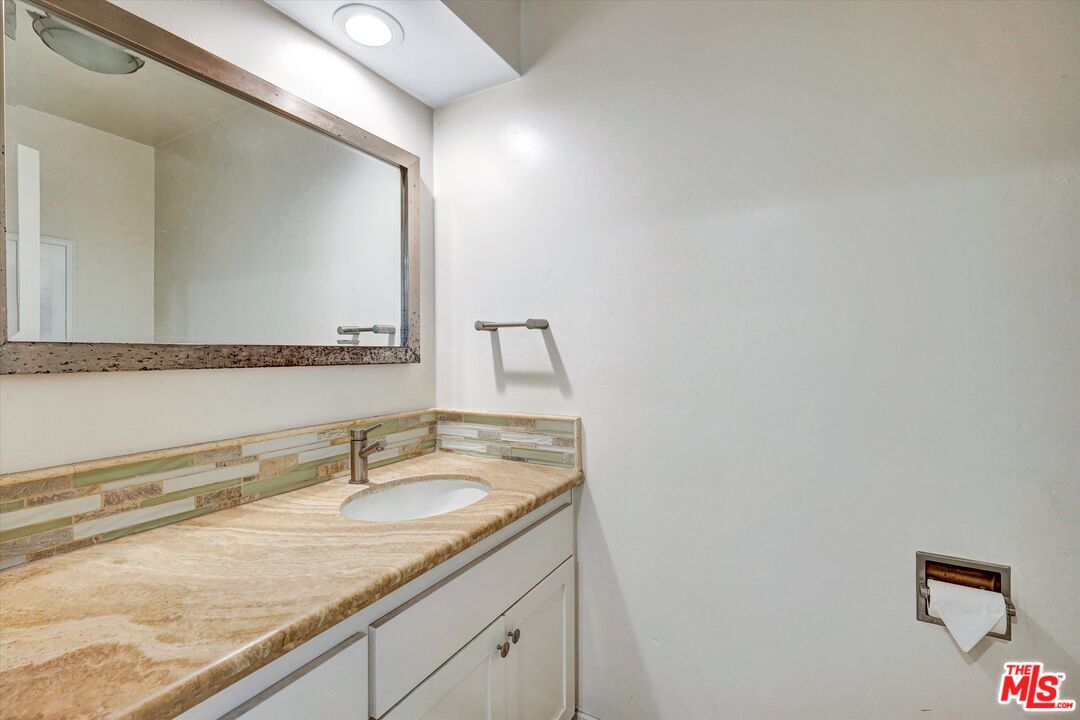 2868 Rutgers Place Oceanside, CA 92056 - Photo 15 of 34 a bathroom with a granite countertop sink and a mirror