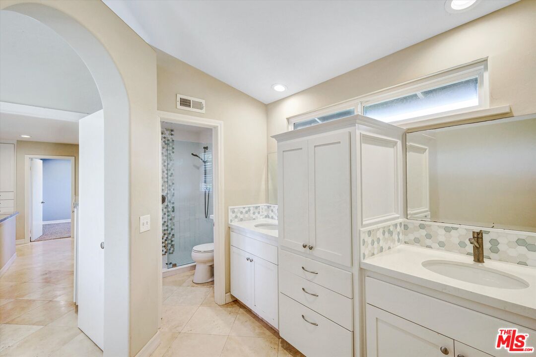 2868 Rutgers Place Oceanside, CA 92056 - Photo 19 of 34 a spacious bathroom with a double vanity sink a toilet and a shower