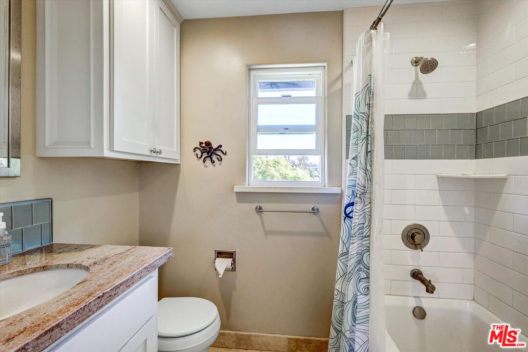 2868 Rutgers Place Oceanside, CA 92056 - Photo 21 of 34 a bathroom with a granite countertop toilet a sink and a shower