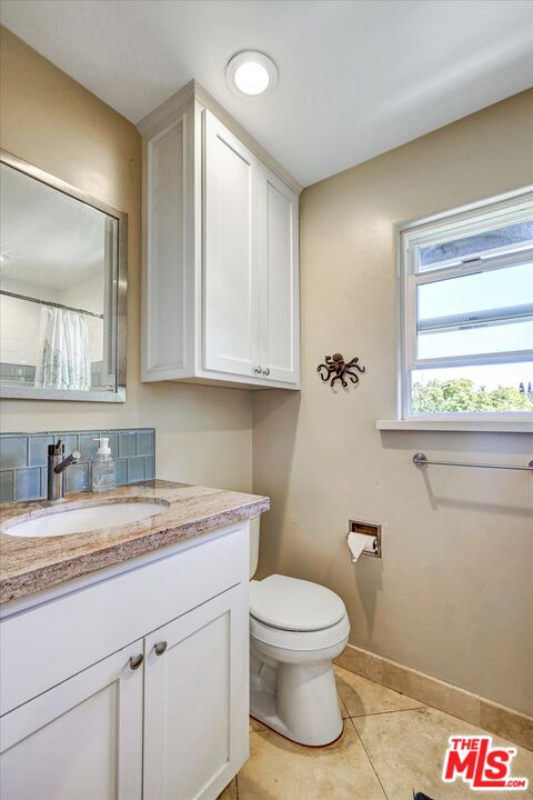 2868 Rutgers Place Oceanside, CA 92056 - Photo 22 of 34 a bathroom with a toilet sink and mirror
