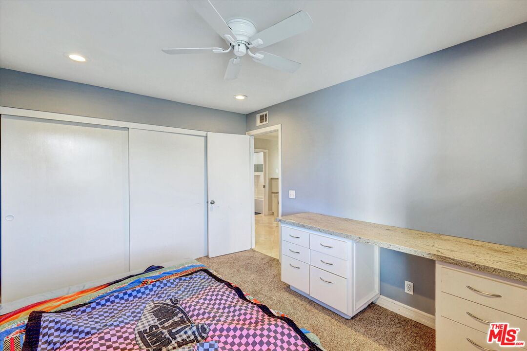2868 Rutgers Place Oceanside, CA 92056 - Photo 26 of 34 a spacious bedroom with a bed and a chandelier