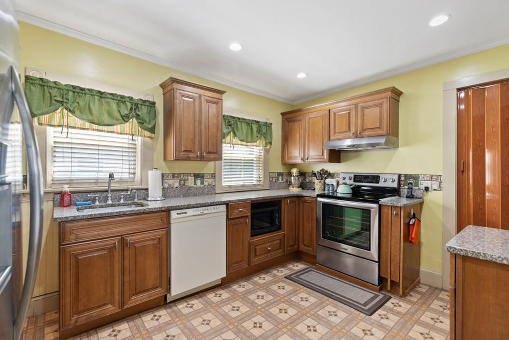 37 Alpine Street Somerville, MA 02144 - Photo 12 of 31 a kitchen with stainless steel appliances granite countertop a stove a sink and a refrigerator
