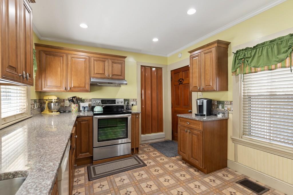 37 Alpine Street Somerville, MA 02144 - Photo 13 of 31 a kitchen with kitchen island granite countertop a stove a sink and a refrigerator
