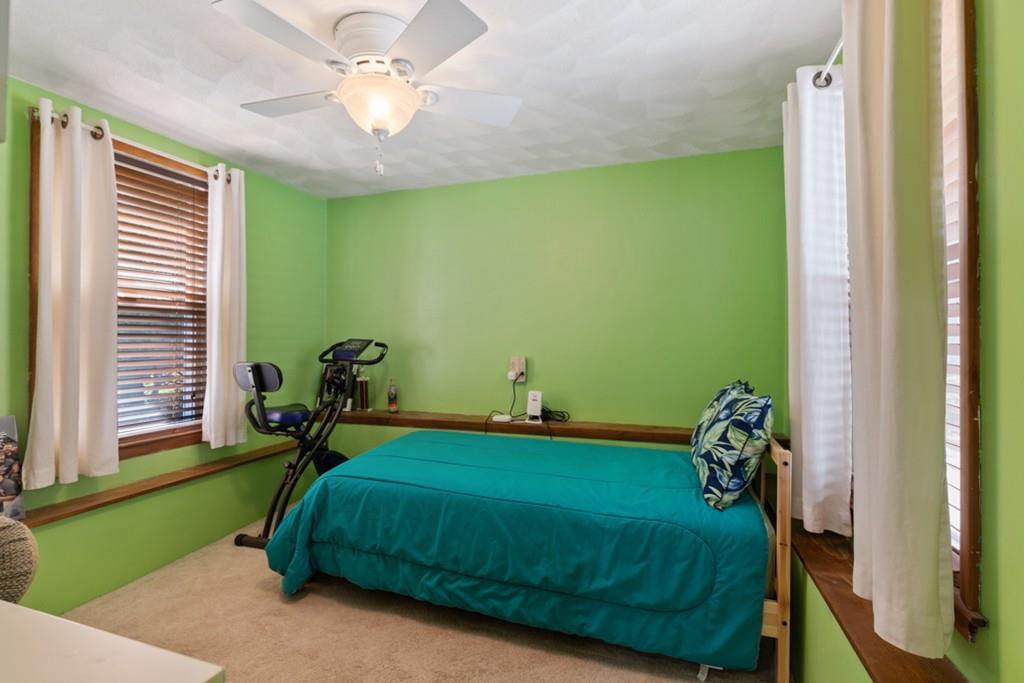 37 Alpine Street Somerville, MA 02144 - Photo 17 of 31 a bedroom with a bed and a chandelier