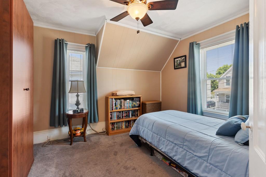 37 Alpine Street Somerville, MA 02144 - Photo 20 of 31 a bedroom with a bed and a chandelier