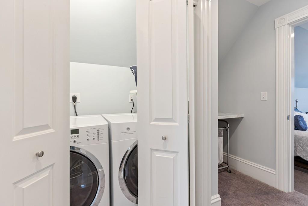 37 Alpine Street Somerville, MA 02144 - Photo 22 of 31 a view of washer and dryer with kitchen in the background