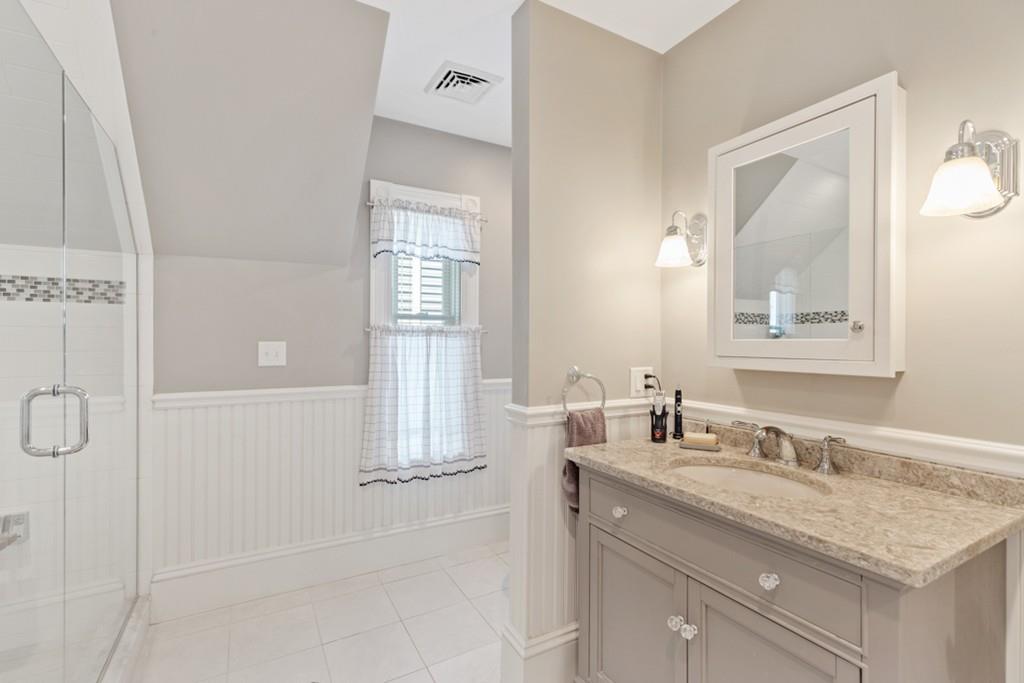 37 Alpine Street Somerville, MA 02144 - Photo 24 of 31 a bathroom with a granite countertop sink a mirror and a shower