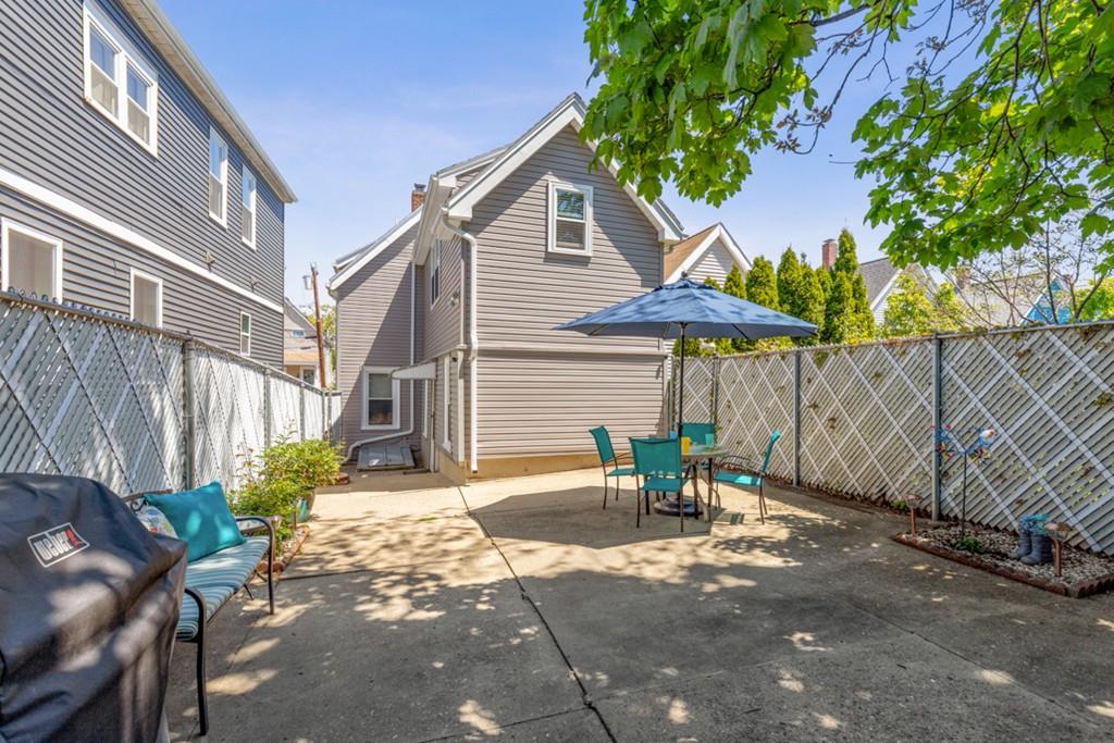 37 Alpine Street Somerville, MA 02144 - Photo 29 of 31 a view of a patio with a table and chairs under an umbrella