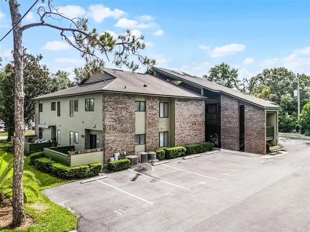 a front view of a house with porch and garden