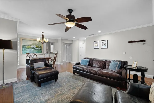 a living room with furniture and a ceiling fan