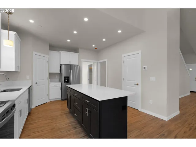 a kitchen with sink cabinets and wooden floor