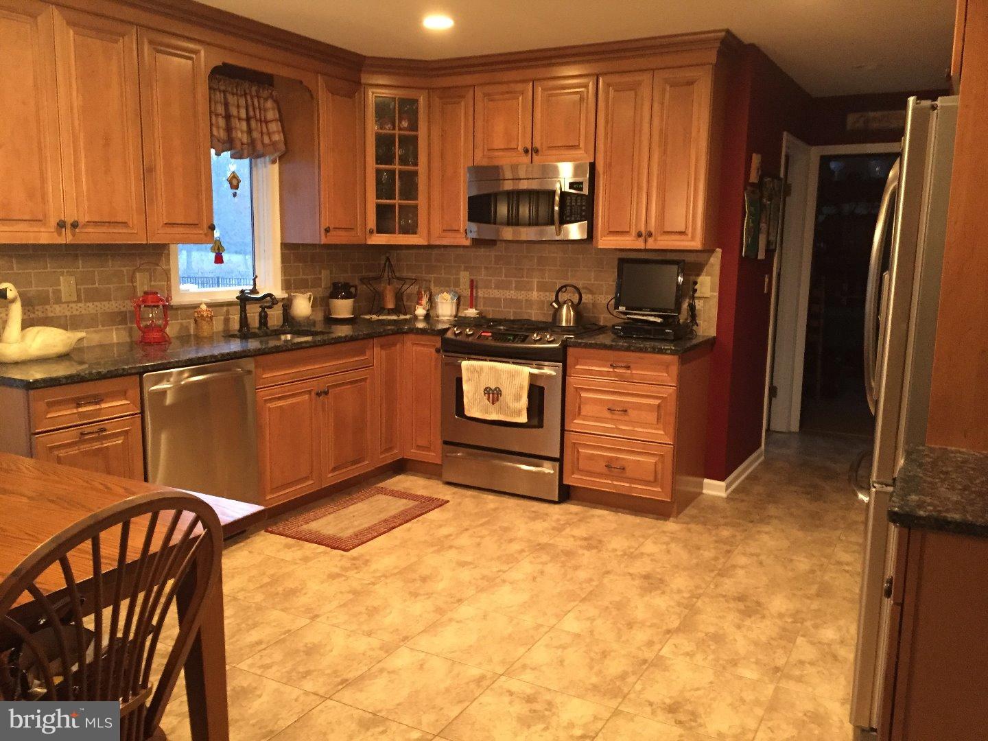 27 Peter Rafferty Drive Hamilton, NJ 08690 - Photo 5 of 15 a kitchen with stainless steel appliances granite countertop a stove refrigerator sink and cabinets