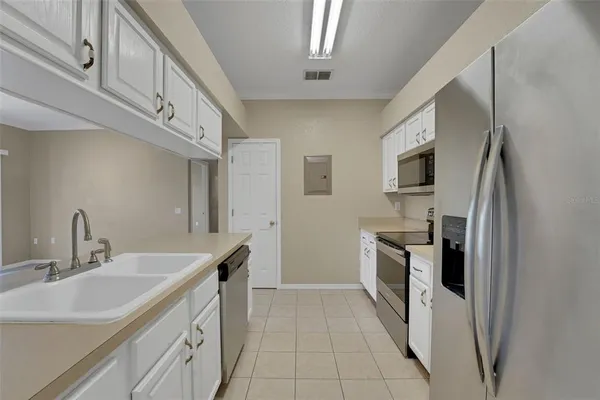 a kitchen with a sink appliances and cabinets