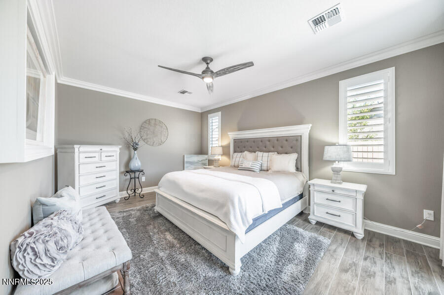 2295 Maximus Lane Reno, NV 89521 - Photo 17 of 62 a bedroom with a bed a window and dresser