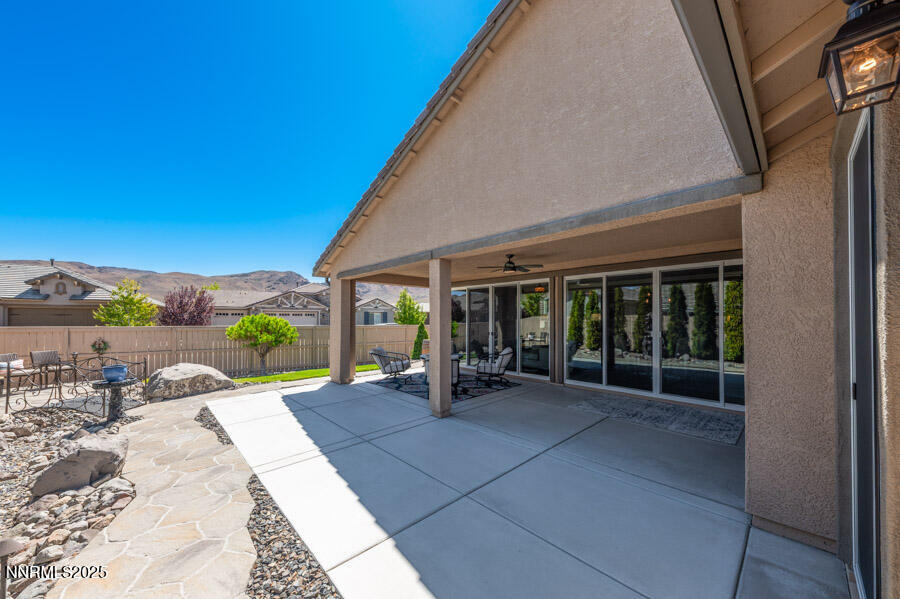 2295 Maximus Lane Reno, NV 89521 - Photo 28 of 62 a view of a patio with table and chairs and wooden fence