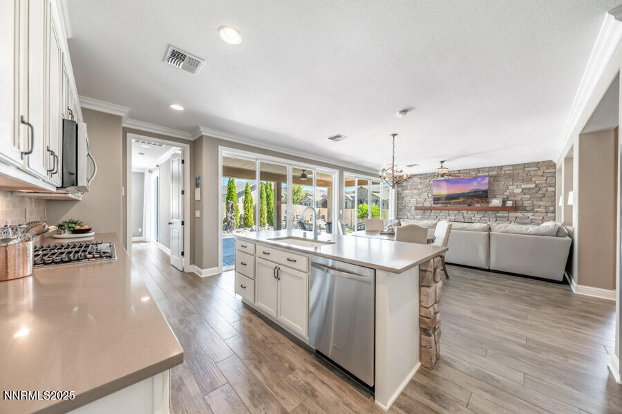 2295 Maximus Lane Reno, NV 89521 - Photo 10 of 62 a kitchen that has a lot of cabinets in it and wooden floors