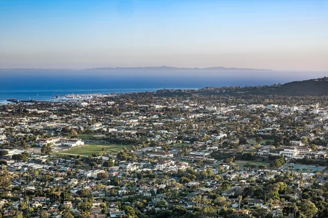 an aerial view of residential building and trees around