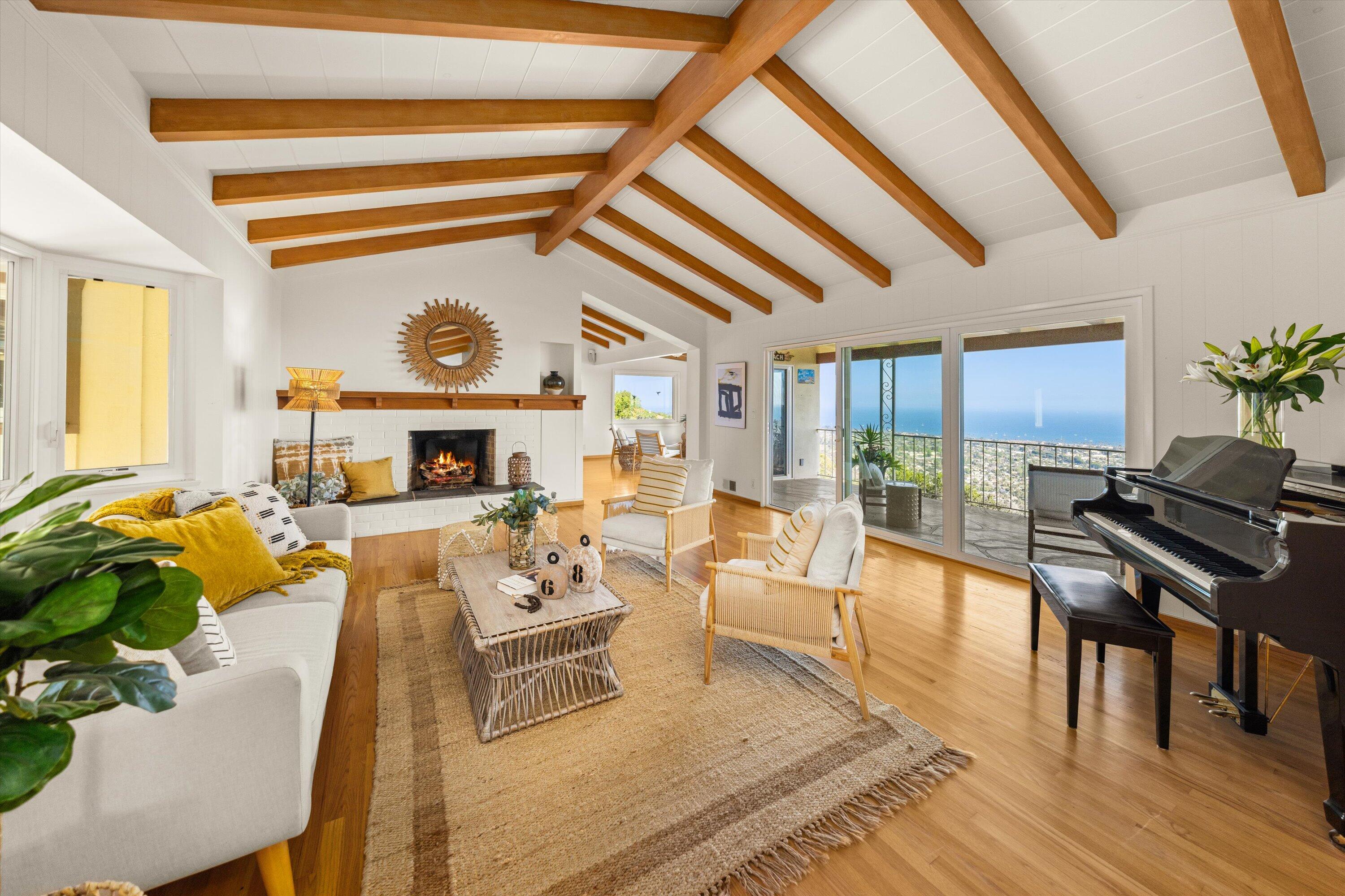 1227 Viscaino Road Santa Barbara, CA 93103 - Photo 2 of 25 a living room with fireplace furniture and a wooden floor