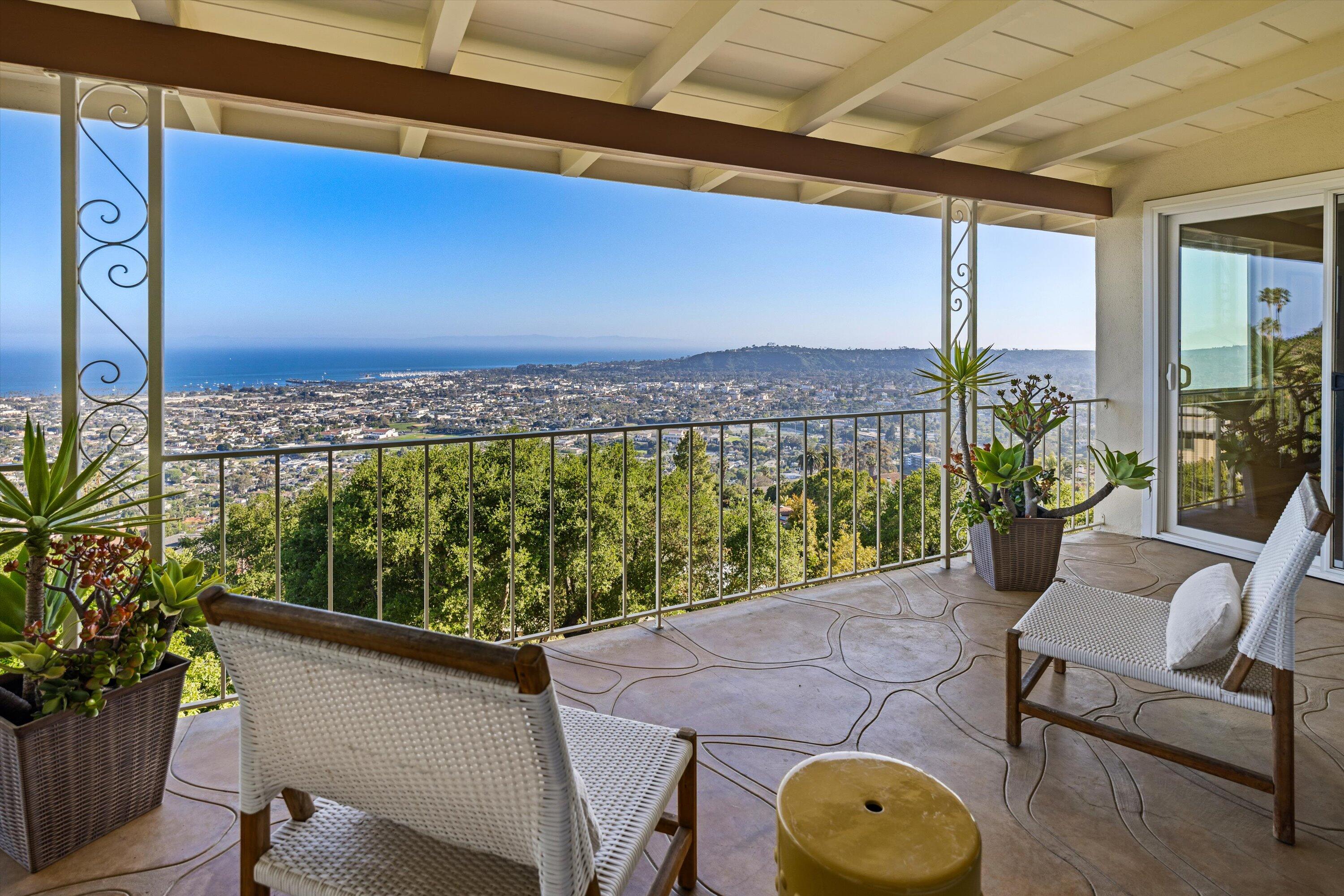 1227 Viscaino Road Santa Barbara, CA 93103 - Photo 3 of 25 a view of a balcony with chair and a potted plant