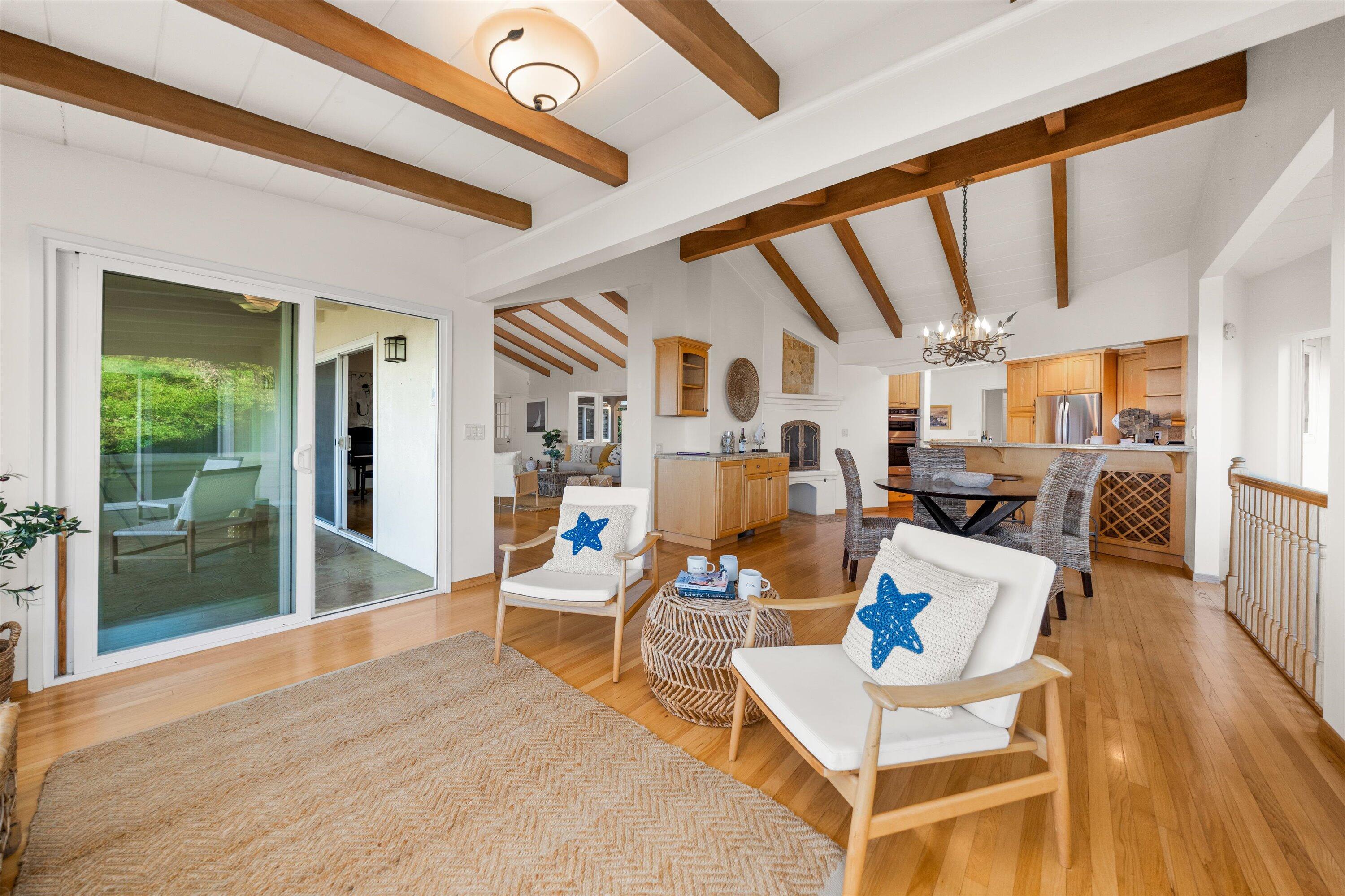 1227 Viscaino Road Santa Barbara, CA 93103 - Photo 9 of 25 a living room with lots of furniture and a chandelier