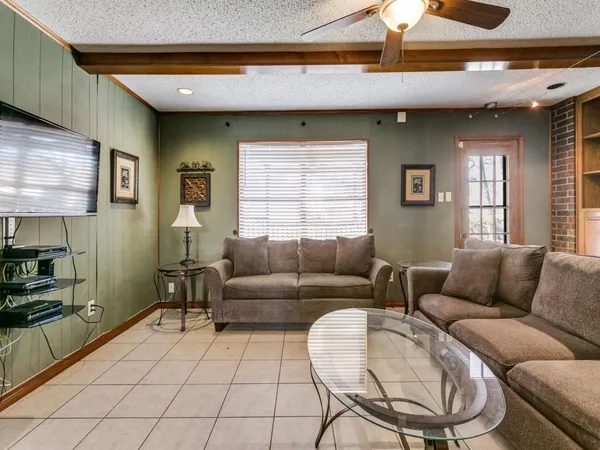 a view of a hallway with wooden floor and a bathroom