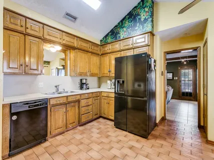 a kitchen with stainless steel appliances granite countertop a stove a sink and a refrigerator
