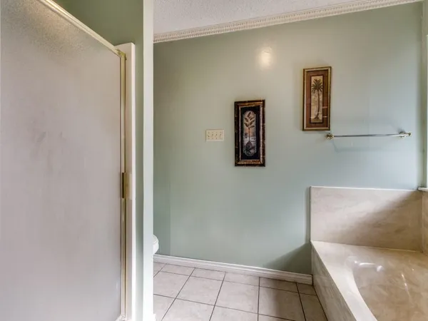 a bathroom with a tub shower and sink