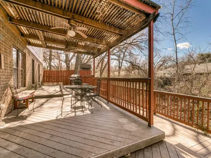 a view of balcony with wooden floor and fence
