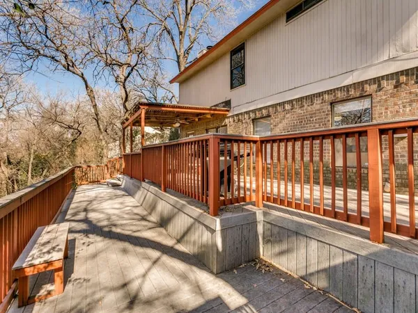a view of a wooden fence and trees