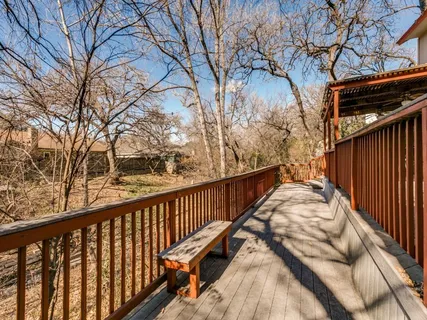 a view of balcony with wooden floor and fence