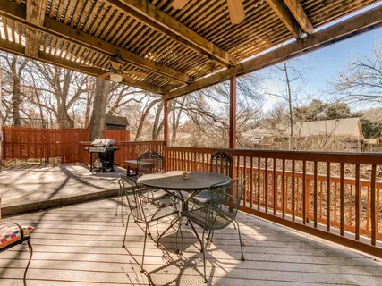 a view of a backyard with sitting area