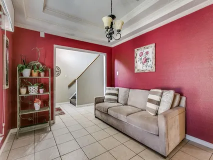 a living room with furniture and a chandelier