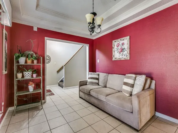 a living room with furniture and a chandelier