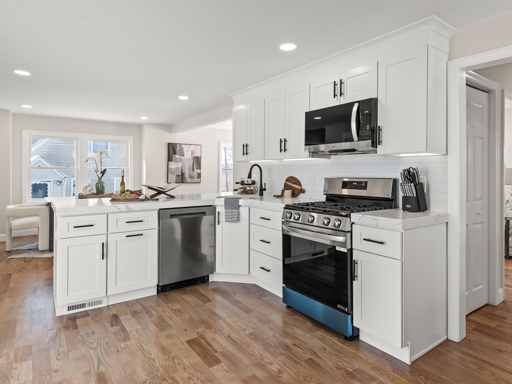 122 Copperfield Road Worcester, MA 01602 - Photo 11 of 30 a kitchen with white cabinets stainless steel appliances and sink