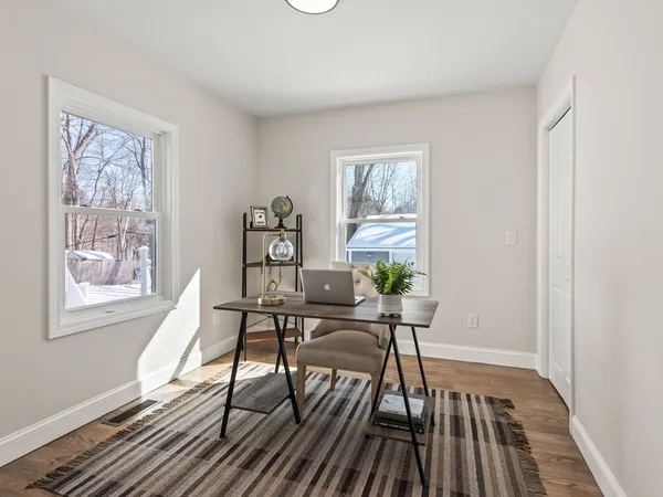 a view of a livingroom with furniture and a window