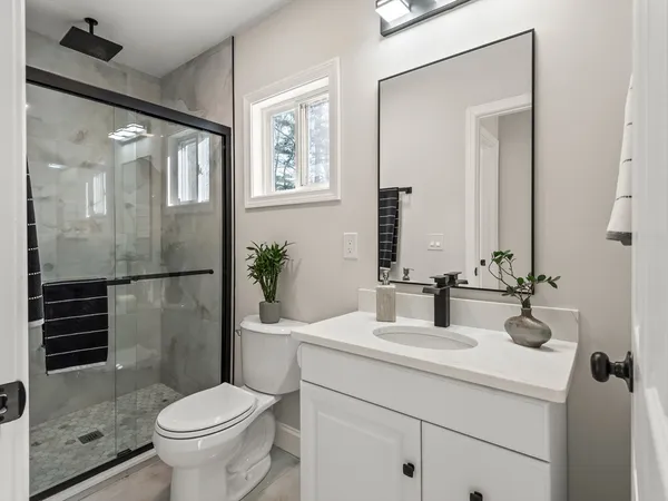 a bathroom with a sink toilet and shower