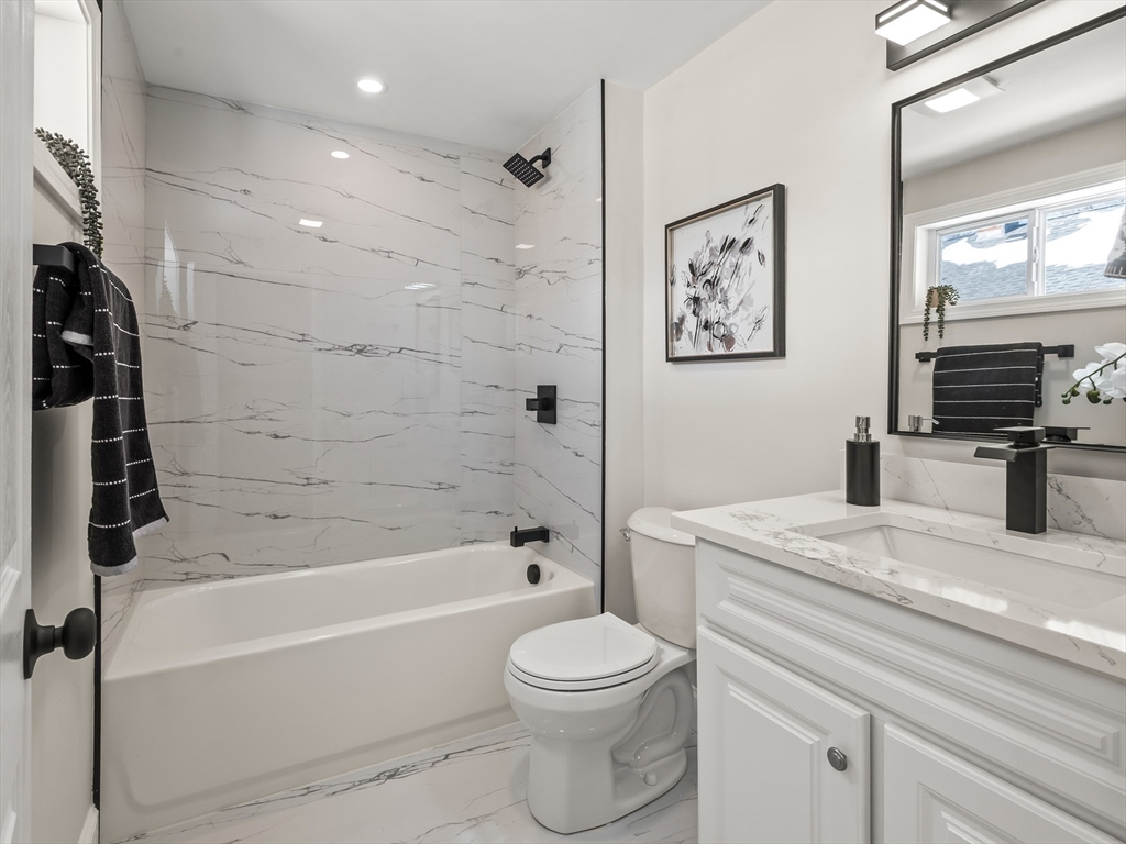 122 Copperfield Road Worcester, MA 01602 - Photo 24 of 30 a bathroom with a granite countertop toilet a sink and bathtub