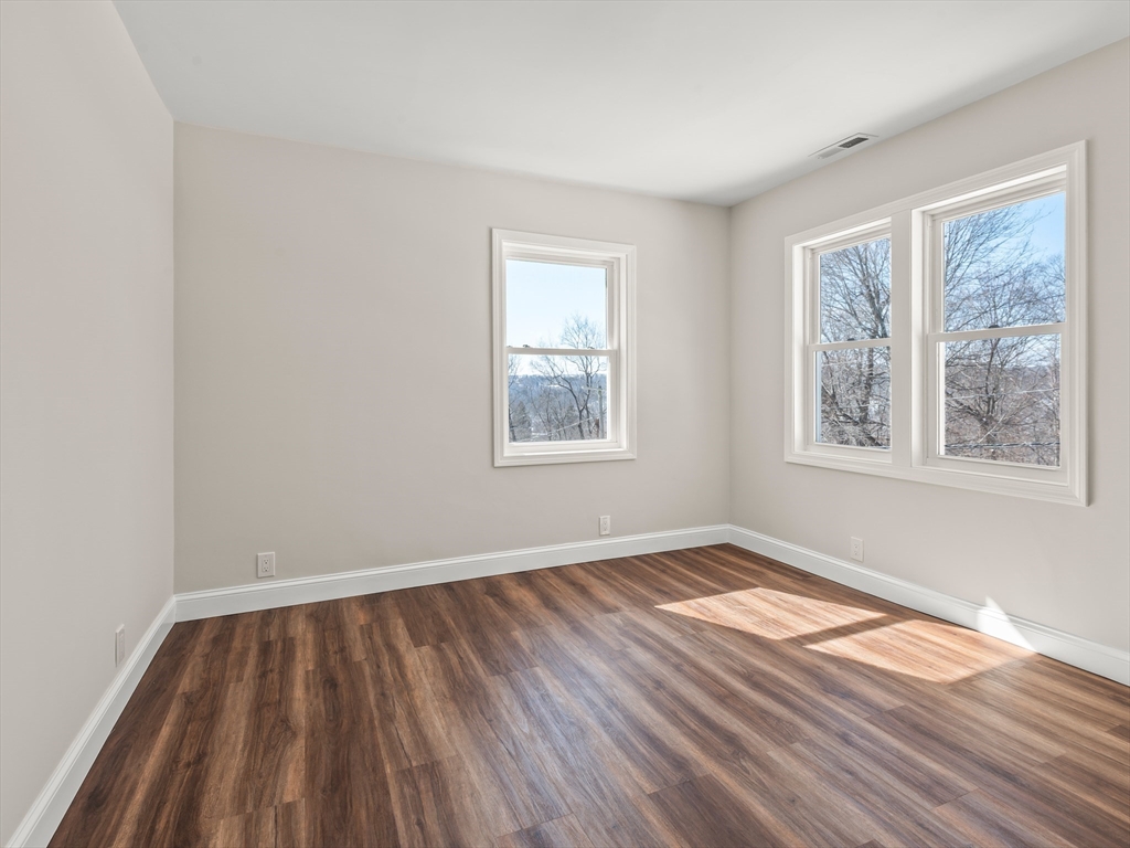 122 Copperfield Road Worcester, MA 01602 - Photo 26 of 30 a view of an empty room with wooden floor and a window