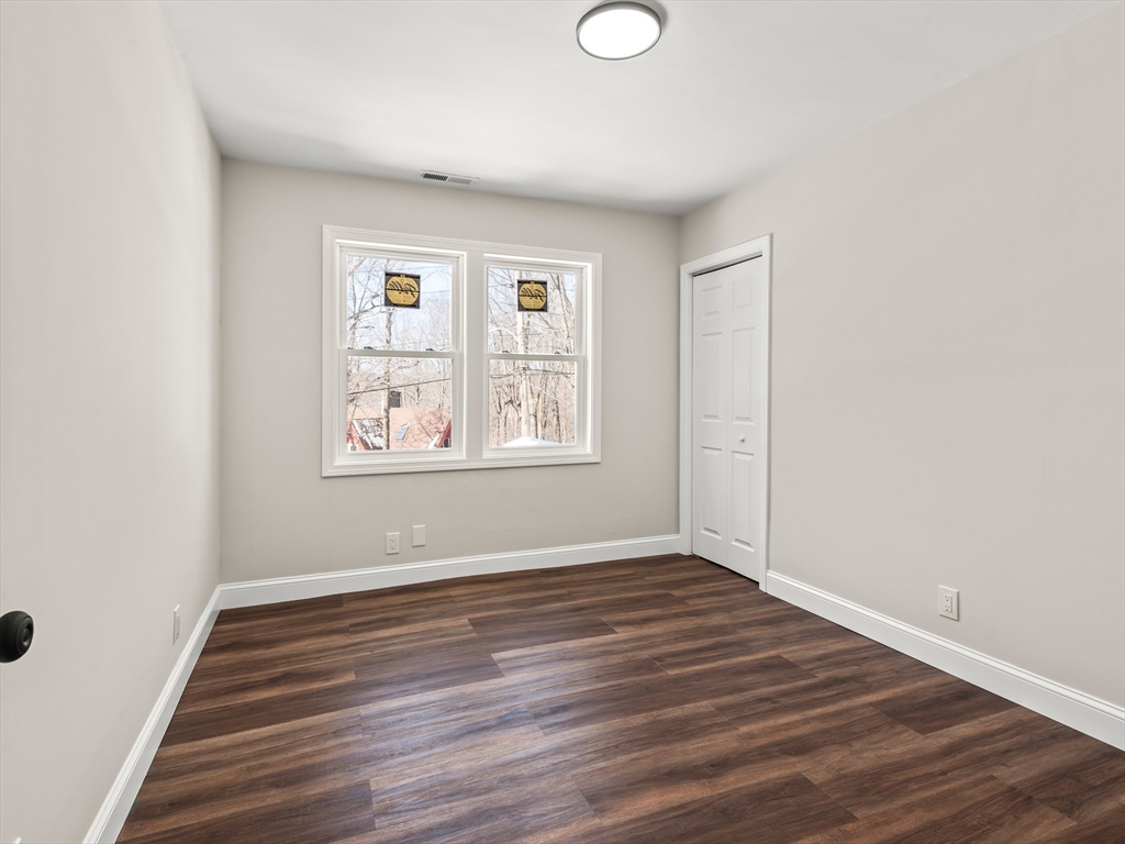 122 Copperfield Road Worcester, MA 01602 - Photo 28 of 30 an empty room with wooden floor and windows