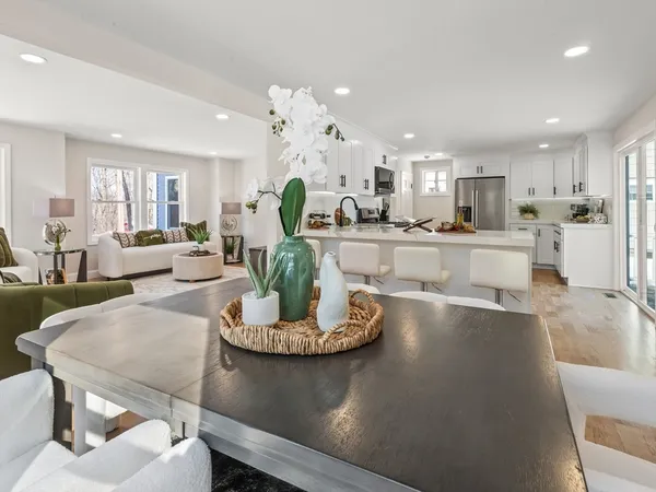 a large kitchen with a table and chairs