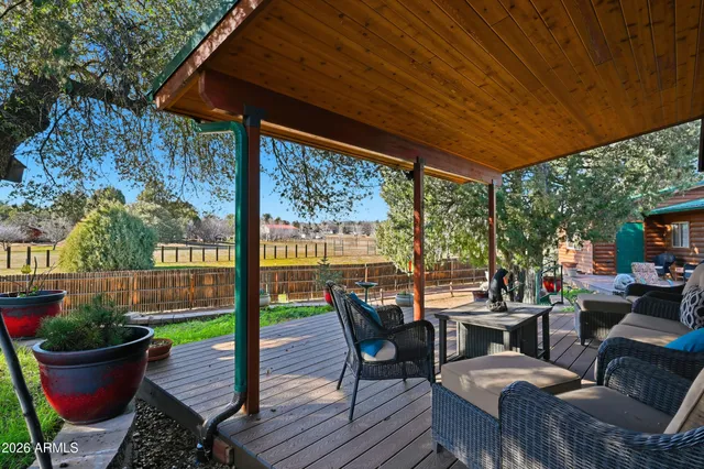 a view of chairs and table in patio with a yard