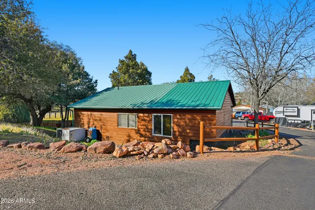 a view of a patio with table and chairs potted plants with wooden floor and fence