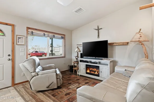 a living room with furniture and a flat screen tv
