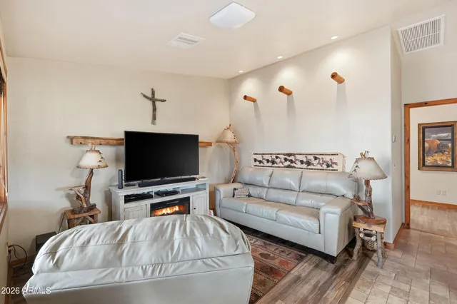 a kitchen with stainless steel appliances granite countertop a refrigerator a stove a sink dishwasher a dining table and chairs with wooden floor